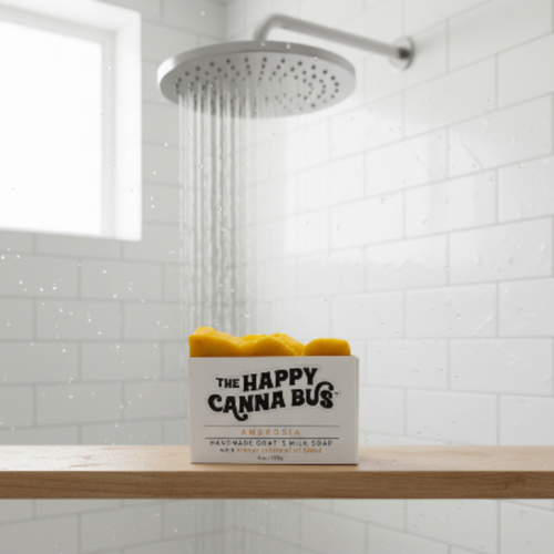 citrus goats milk soap handmade 'The Happy Canna Bus' on a bathroom shelf with a shower head in the background olive oil no palm oils